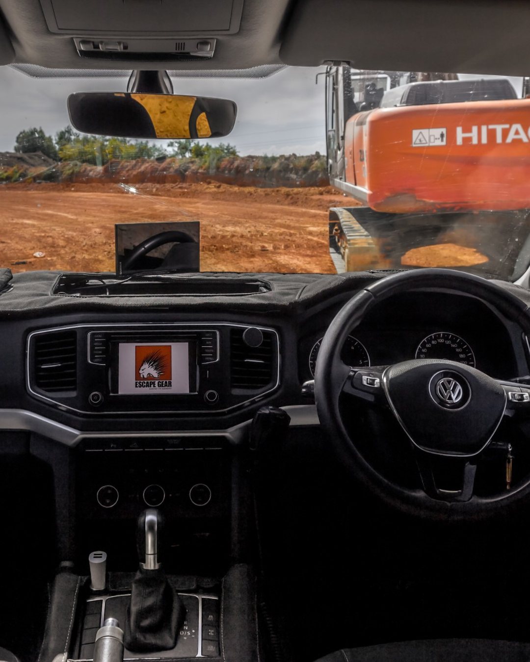 Escape Gear: the cab of a bakkie with the Escape Gear logo on the dashboard screen