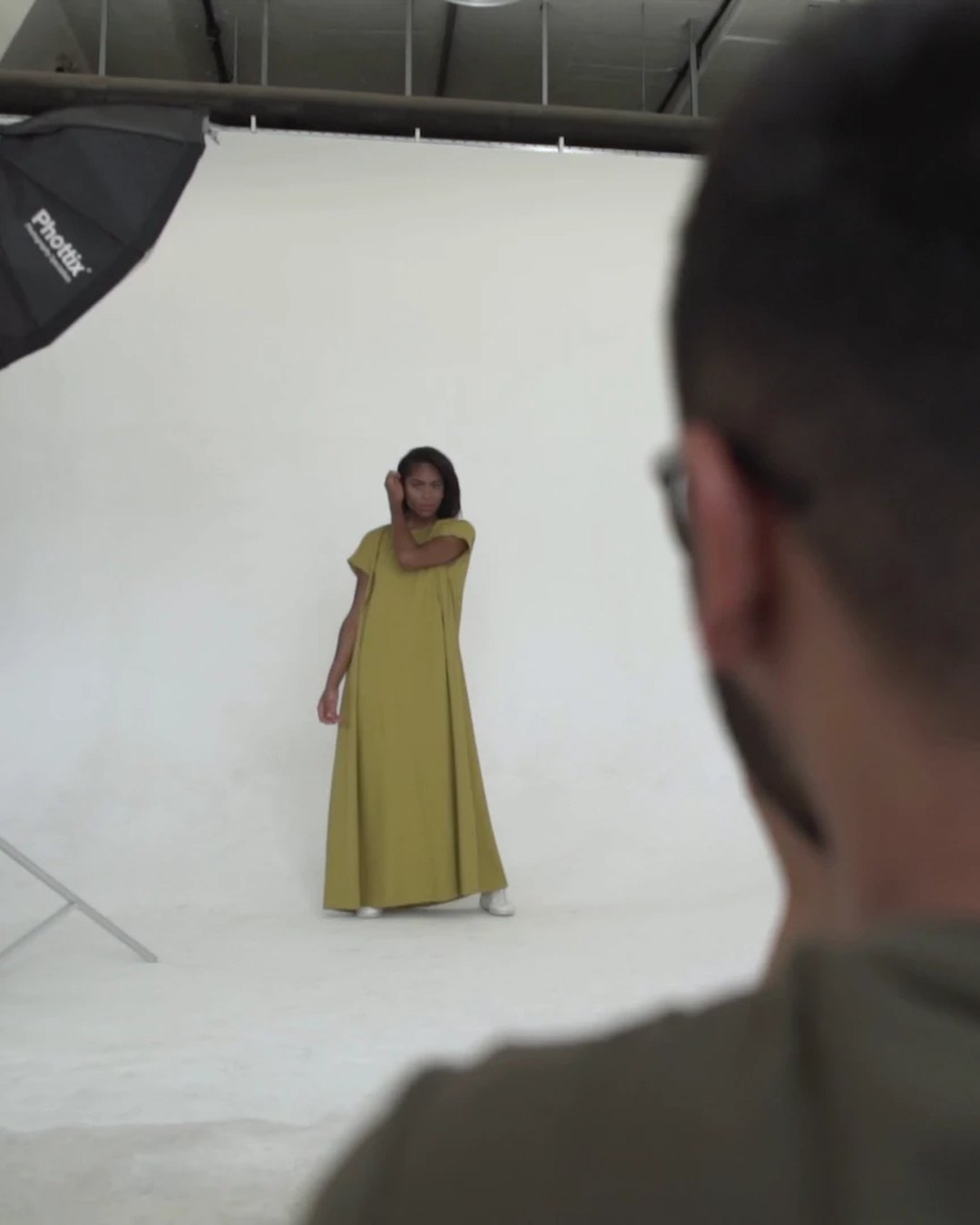 Streetlines: the photographer shooting the model in a long ochre dress